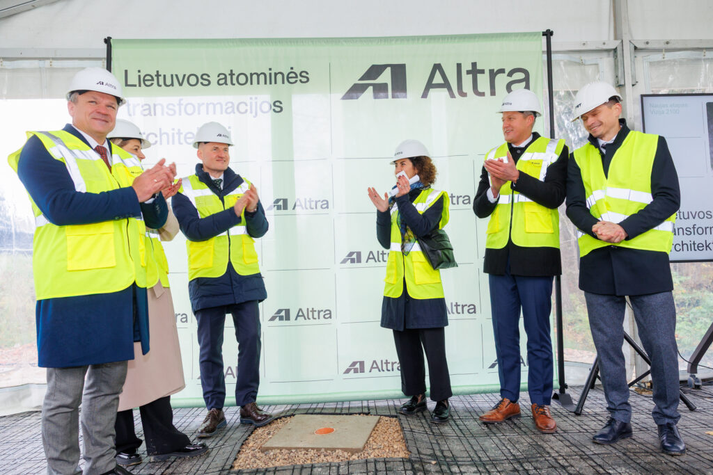 Atliekyno kapsulės įkasimo renginys, matomi įvairių organizacijų atstovai, užkasantys kapsulę