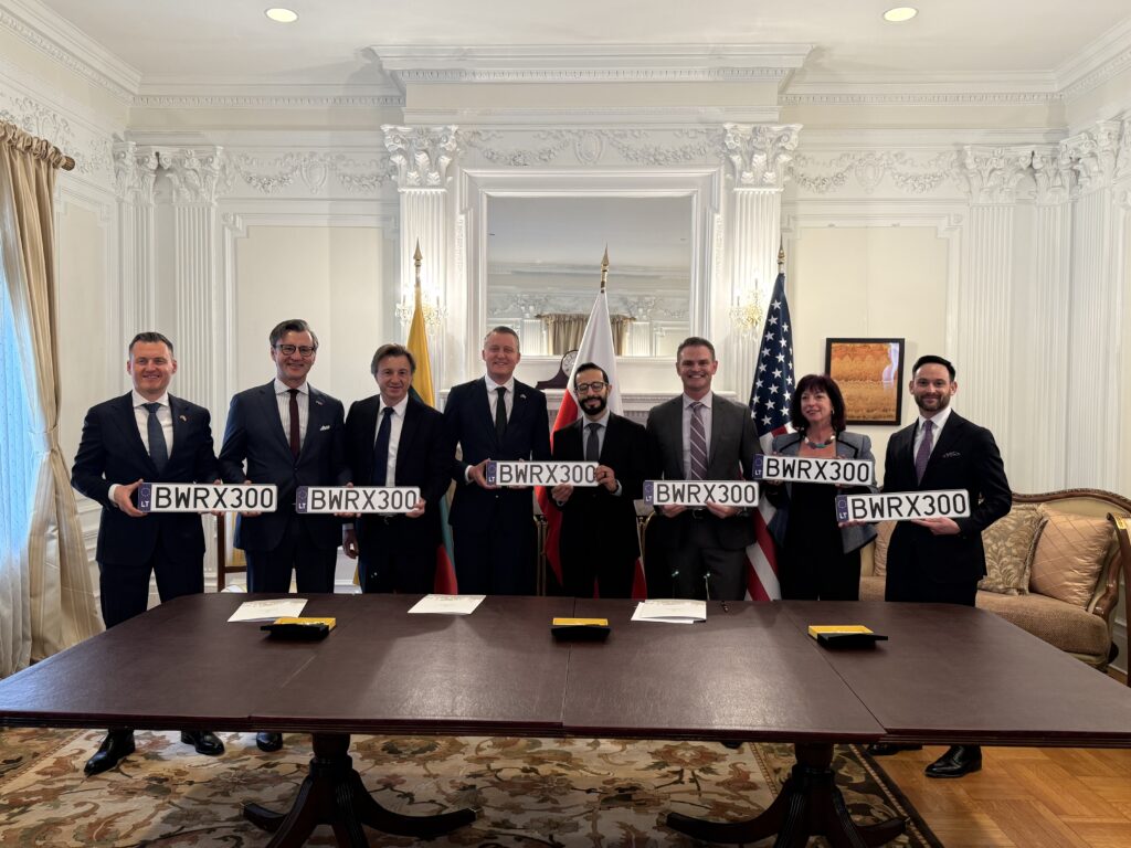 Participants of the memorandum signing ceremony present the signed documents after the official signing.