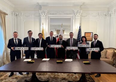 Participants of the memorandum signing ceremony present the signed documents after the official signing.