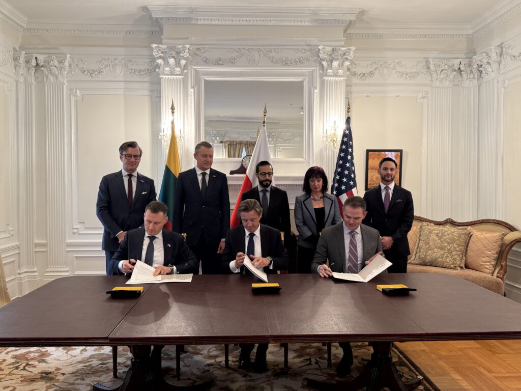 Representatives sign the memorandum during the official signing ceremony.