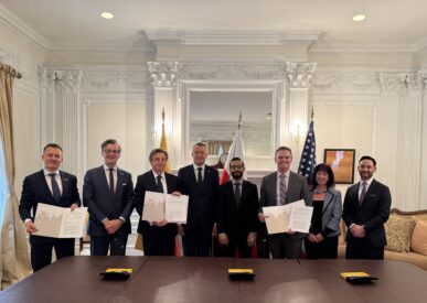 Participants of the memorandum signing ceremony present the signed documents after the official signing.