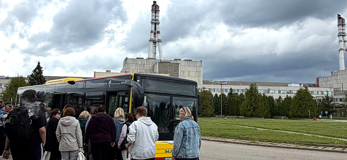 žmonės lipa į autobusą